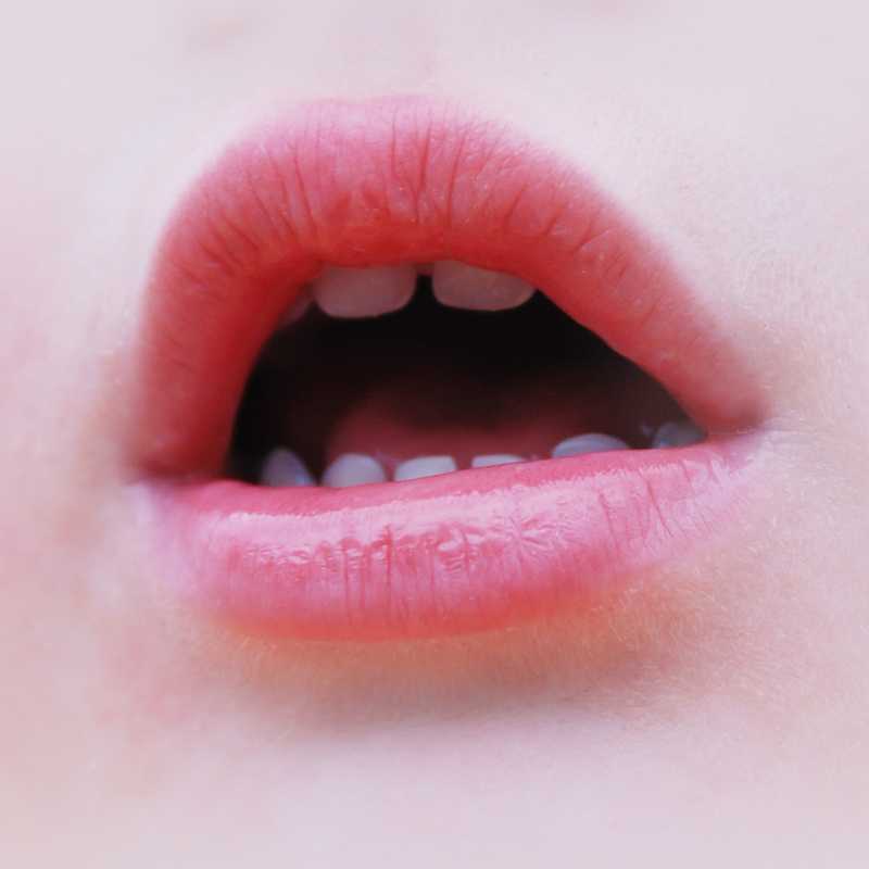 pink lips of an opened mouth of a curious little girl